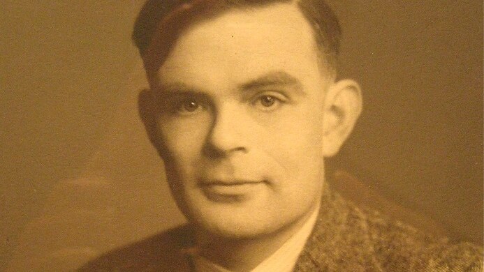 A sepia portrait photograph of Alan Turing.