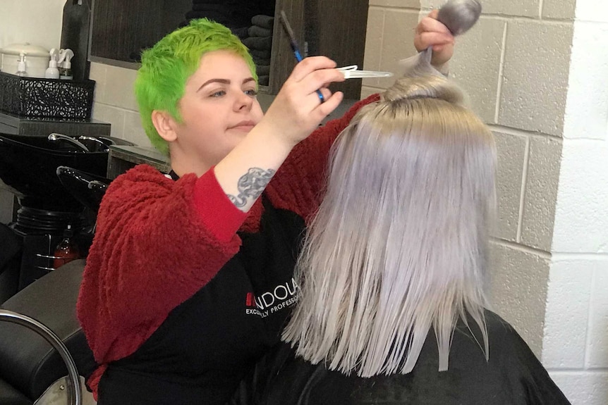 Drag performer Katie Eastley working in her day job as a hairdresser
