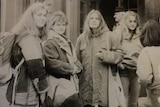 1987 black-and-white image of four East German women standing in front of sandstone building.