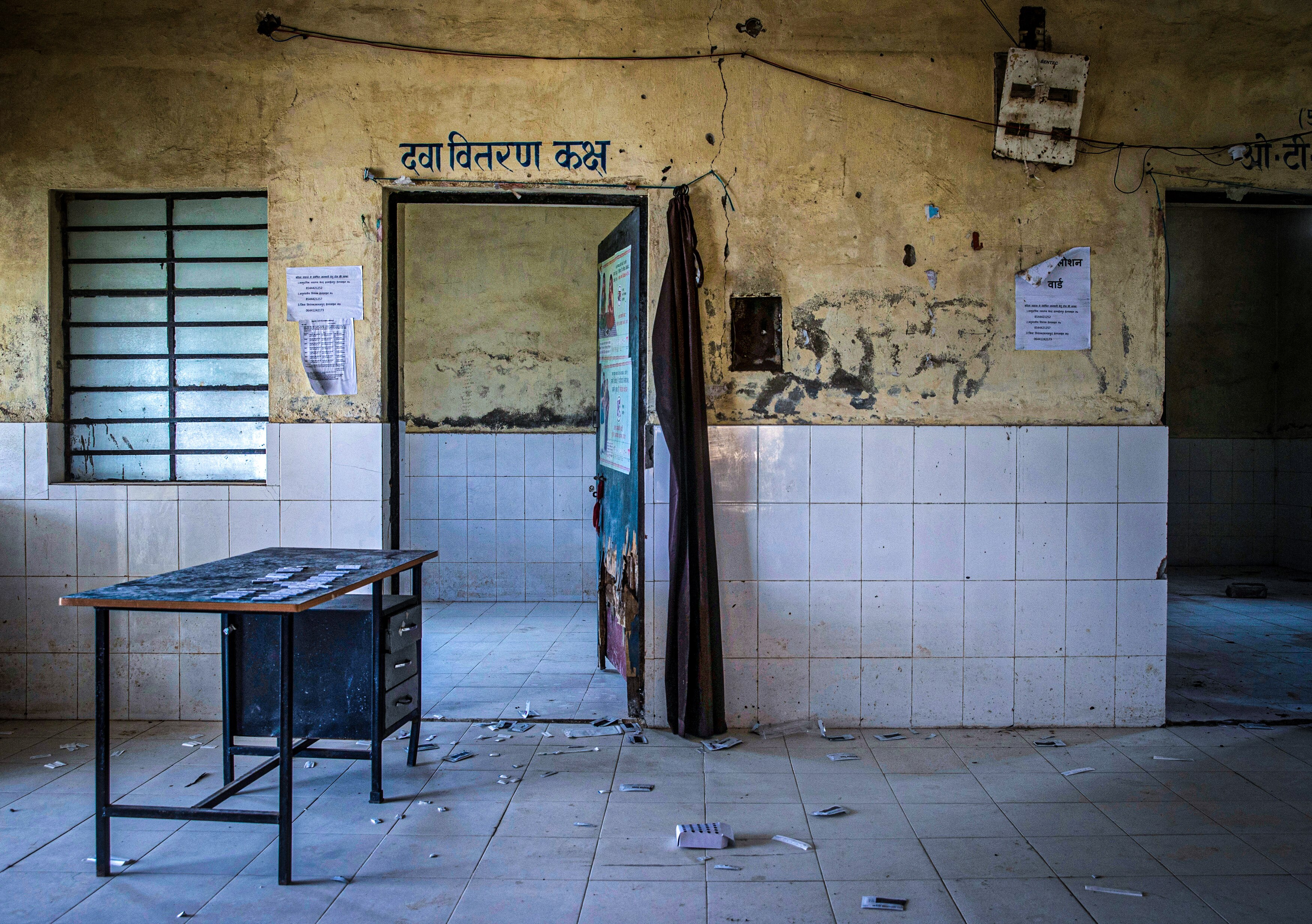 An empty room with used COVID-19 tests on the floor