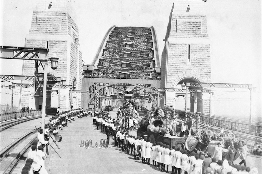 people standing along the road to the harbour bridge when it first opened