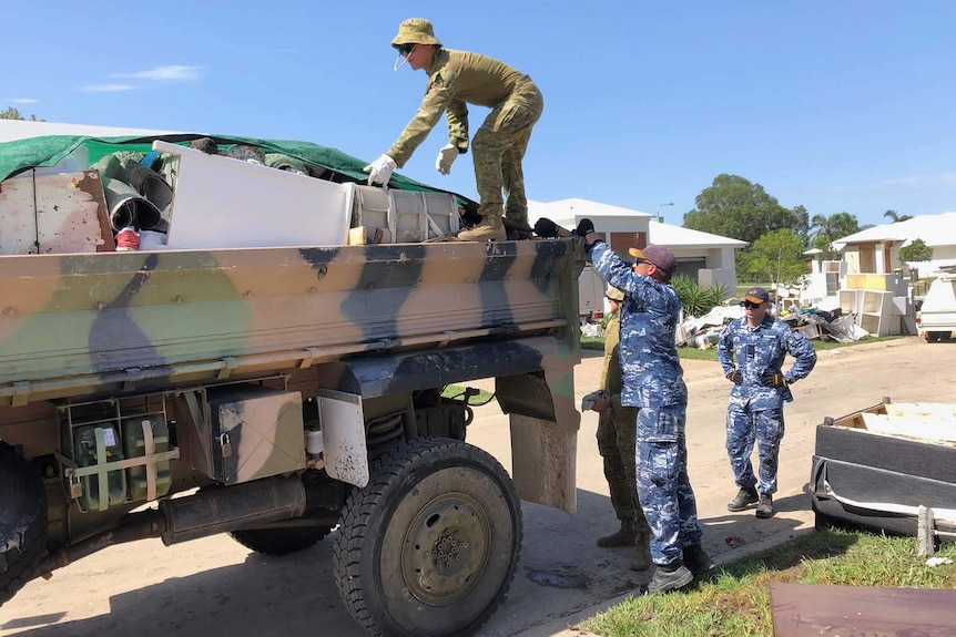 Soldiers remove flood damaged items from houses in the Townsville suburb of Mundingburra on 11 February, 2019.