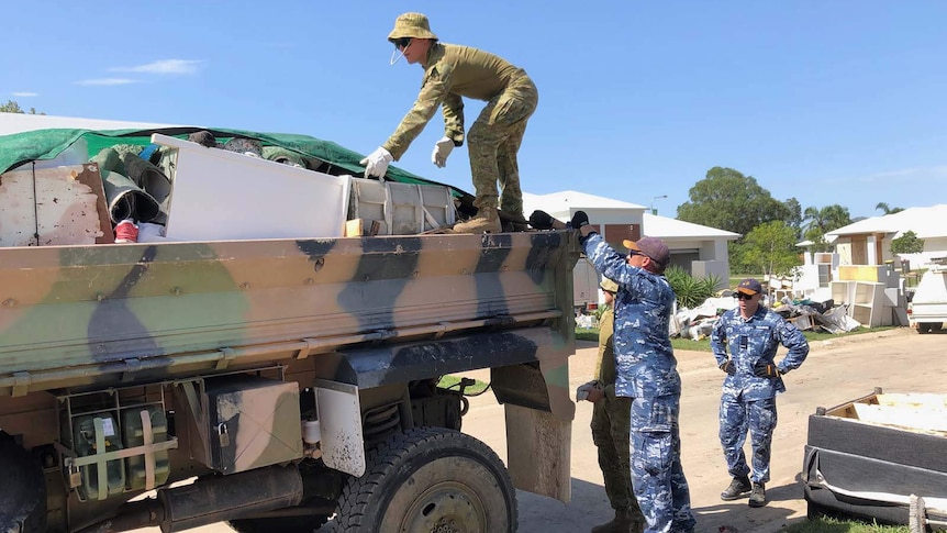 Soldiers remove flood damaged items from houses in the Townsville suburb of Mundingburra on 11 February, 2019.