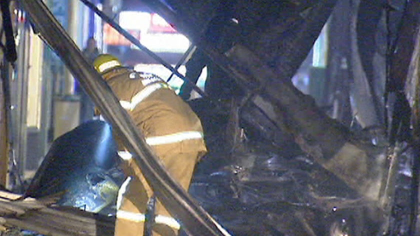 A fire fighter examines the scene after the accident.