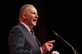 Anthony Albanese speaks at a microphone looking forceful