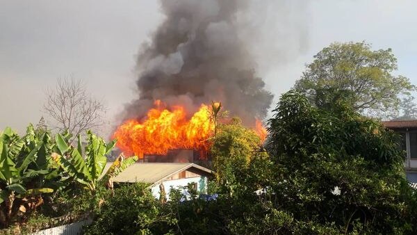 Flames and smoke rose from a house burning in the town of Goroka.