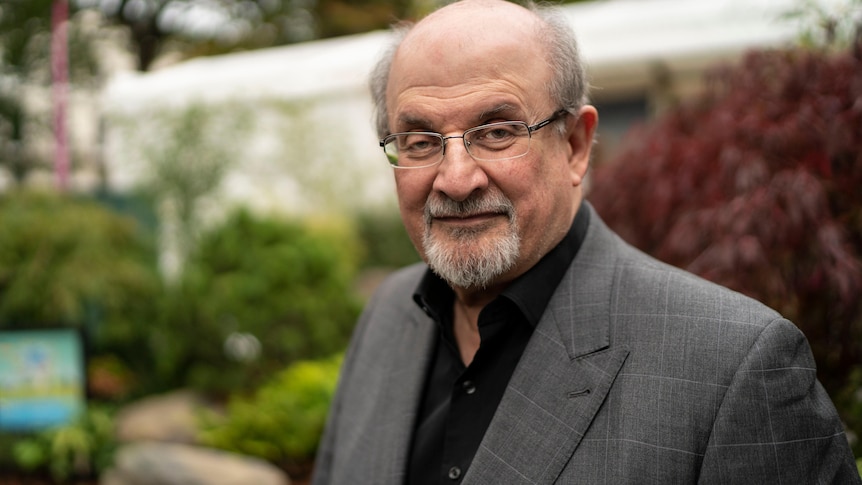 portrait of Salman Rushdie wearing suit outdoors