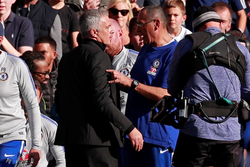 Jose Mourinho and Maurizio Sarri speak during a heated exchange.