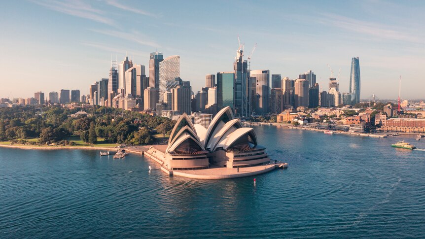 The Sydney Opera House on Sydney Harbour with buildings in the background