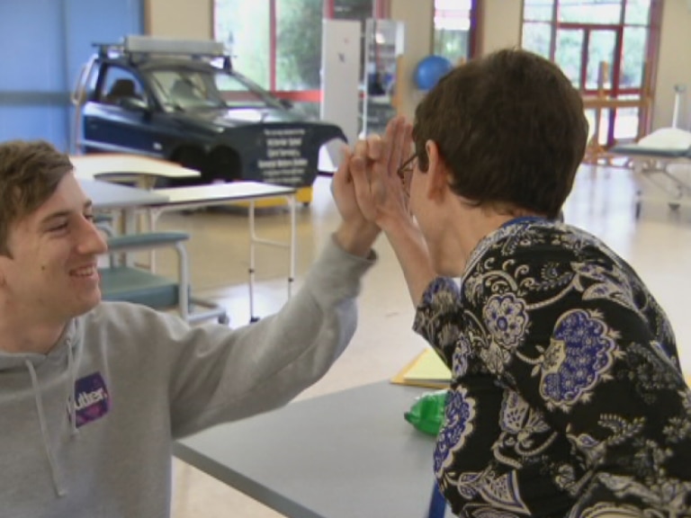 Jack smiles gives his surgeon a high-five