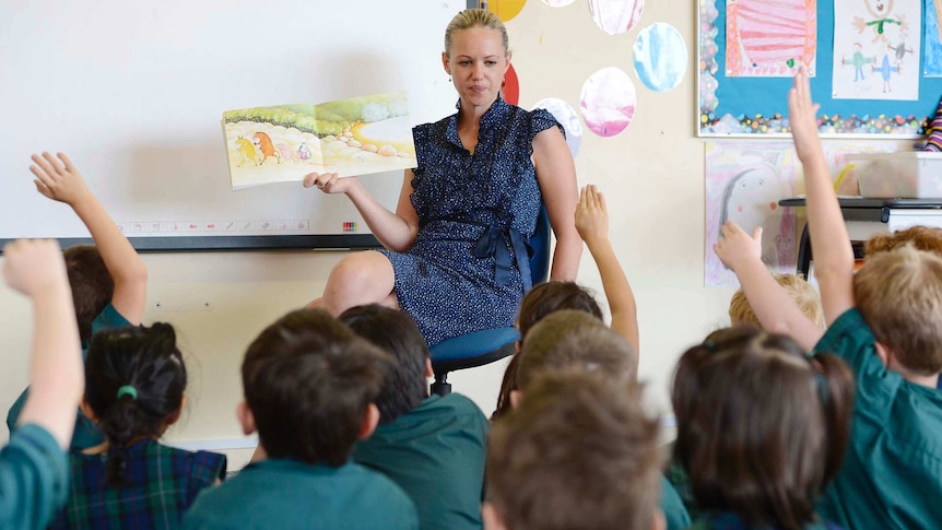 A teacher talks to primary school students in Brisbane on April 15, 2013.
