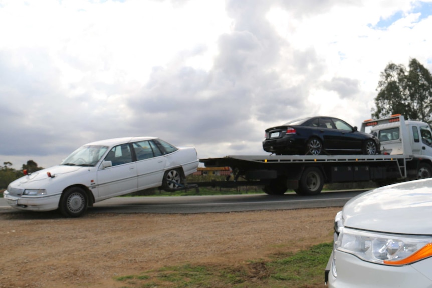 Police remove two cars from the scene