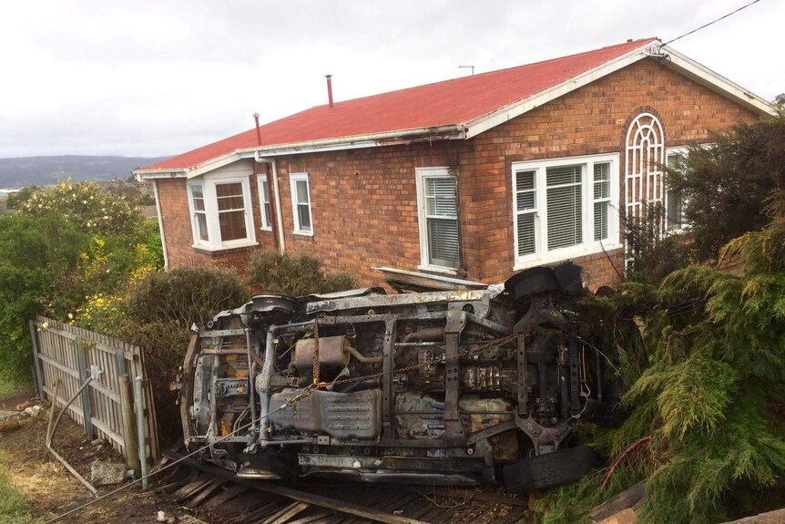 Burnt car lands on roof in Launceston