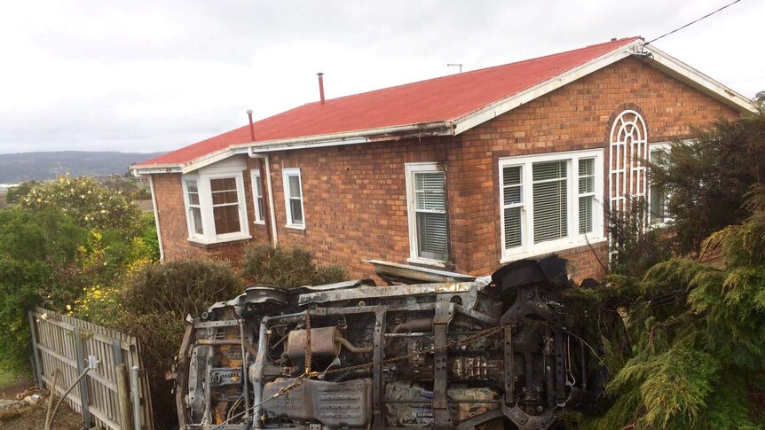 Burnt car lands on roof in Launceston