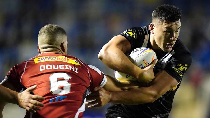 New Zealand's Joey Manu tries to get past Adam Doueihi of Lebanon at the Rugby League World Cup.