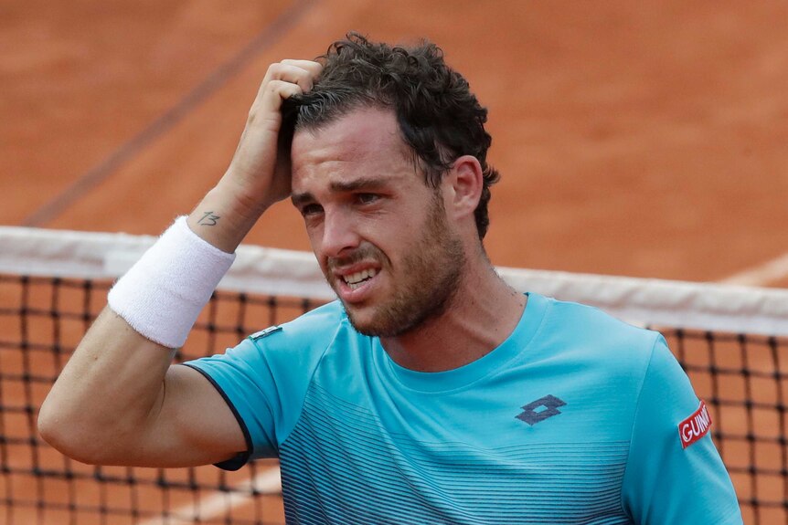 Italy's Marco Cecchinato cries as he celebrates beating Novak Djokovic at the French Open.
