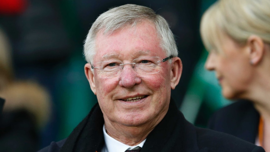 Sir Alex Ferguson watching a football game in the stands