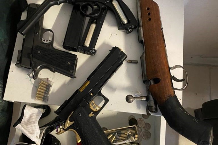A shot gun and other guns seized in the raid.