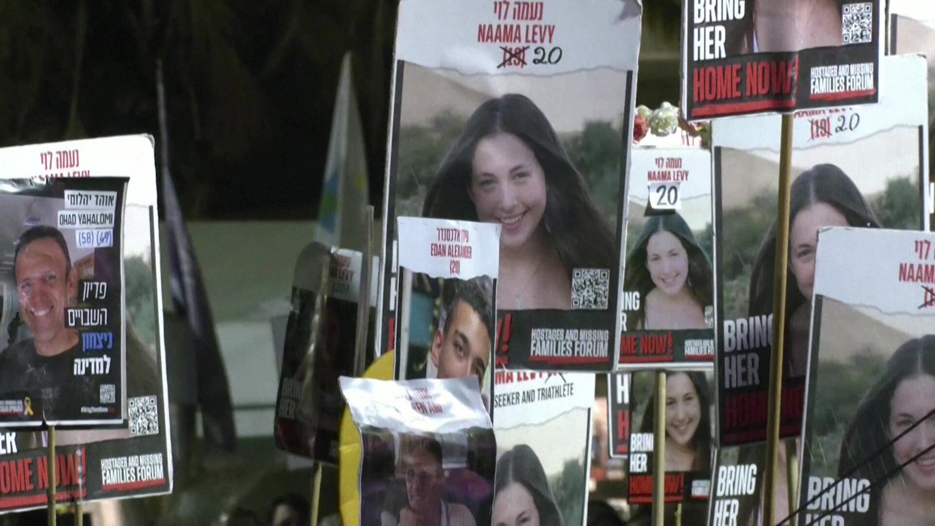 Placards of hostages held at rally in Israel calling for release of those held captive.