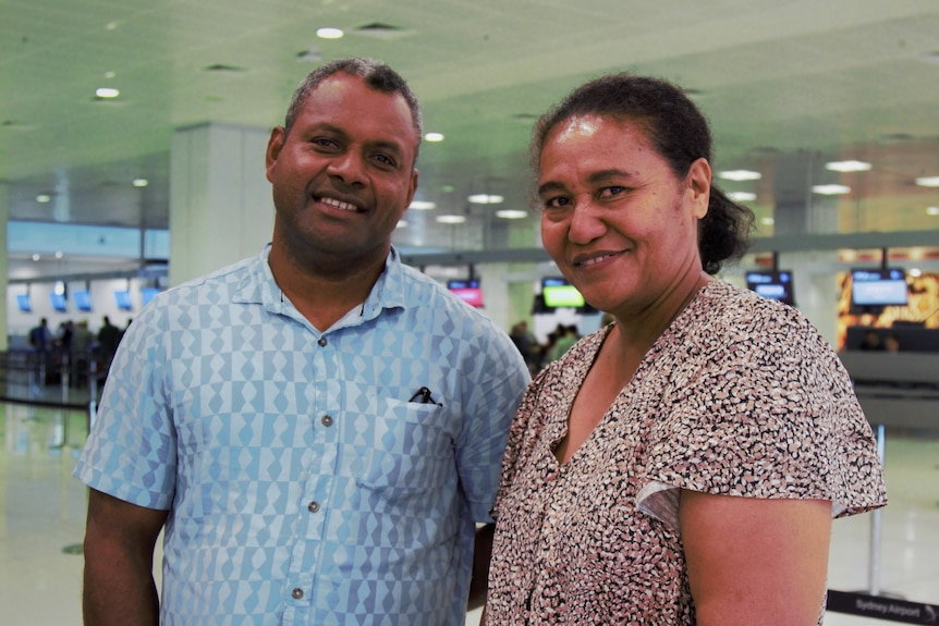 Seasonal worker couple Sami Toganivalu and Lite Sivu stand in an airport in Suva