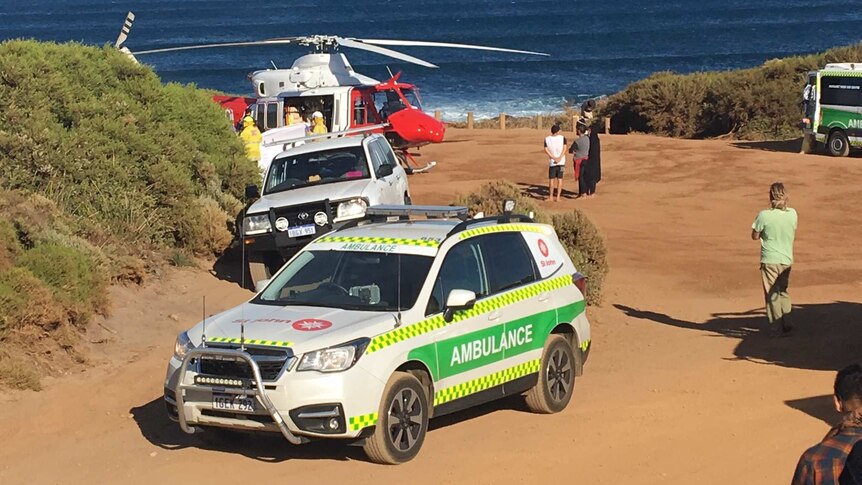 An ambulance and rescue helicopter in a carpark at a beach near Gracetown in WA's South West.