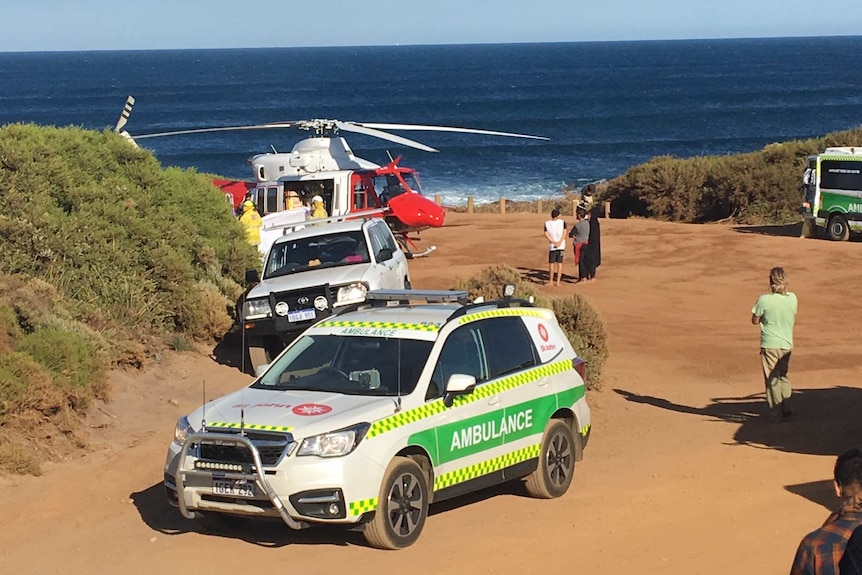 An ambulance and rescue helicopter in a carpark at a beach near Gracetown in WA's South West.