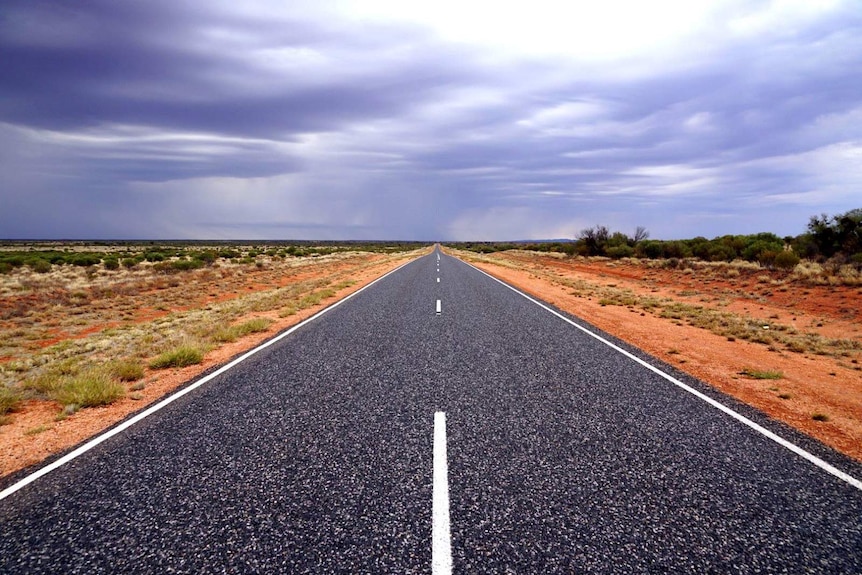 A view of a highway in the Northern Territory on an overcast day.