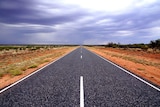 A view of a highway in the Northern Territory on an overcast day.