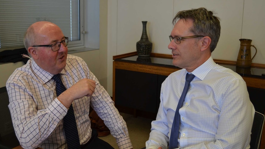 Guy Debelle (right) speaks with the ABC's Peter Ryan about the global financial crisis.