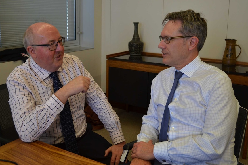 Guy Debelle (right) speaks with the ABC's Peter Ryan about the global financial crisis.