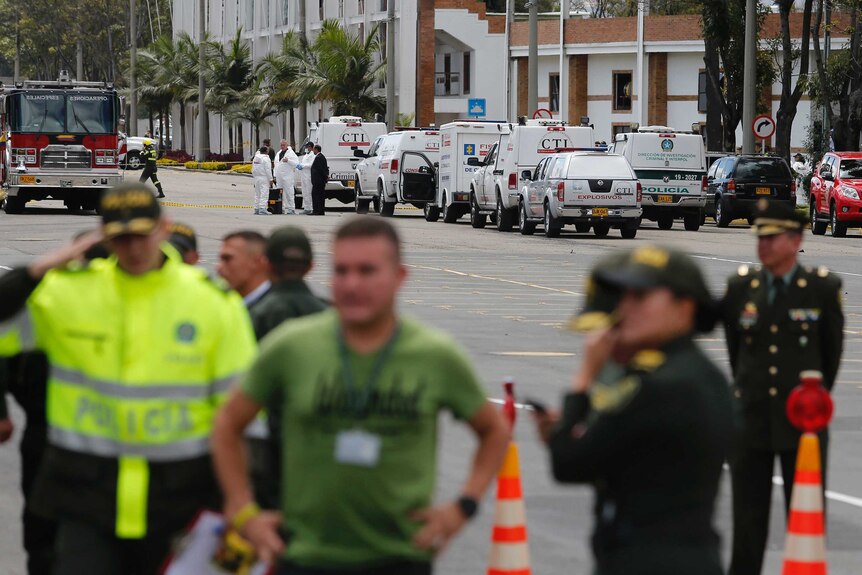 Forensic workers at the scene of the Bogota police academy car bombing.