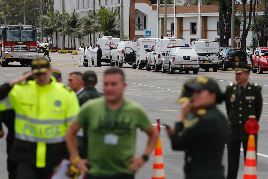 Forensic workers at the scene of the Bogota police academy car bombing.