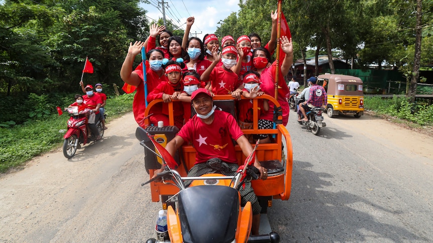 Supporters wearing shirts with logos of Aung San Suu Kyi's National League for Democracy.