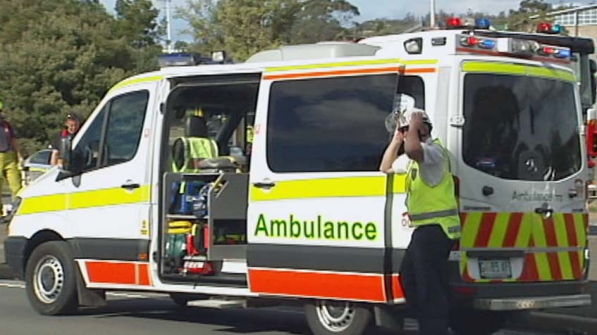 Tasmanian ambulance, parked on a road with door open