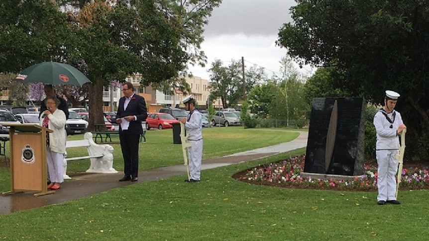 Cadets on guard while Indigenous Elder speaks at a ceremony to open Indigenous war memorial in a park.