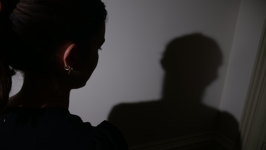 A dark picture of a woman's back of head