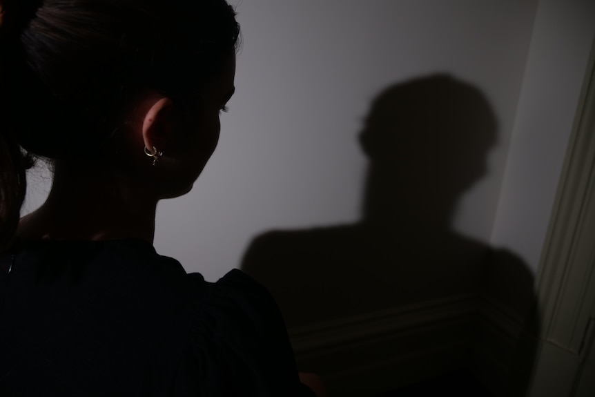 A dark picture of a woman's back of head