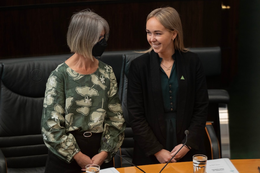 Two female politicians in parliament.