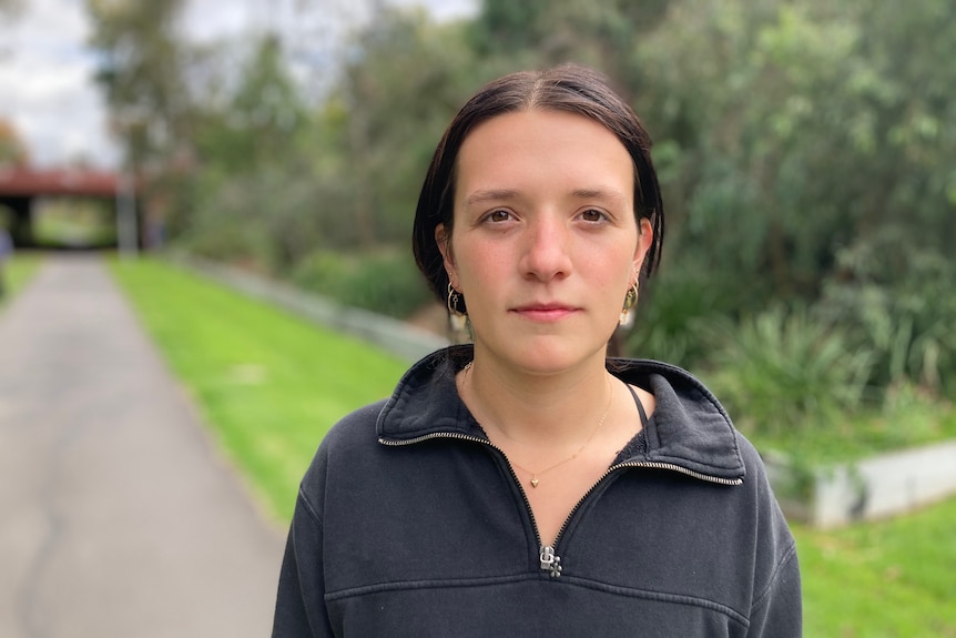 A young woman near an underpass.