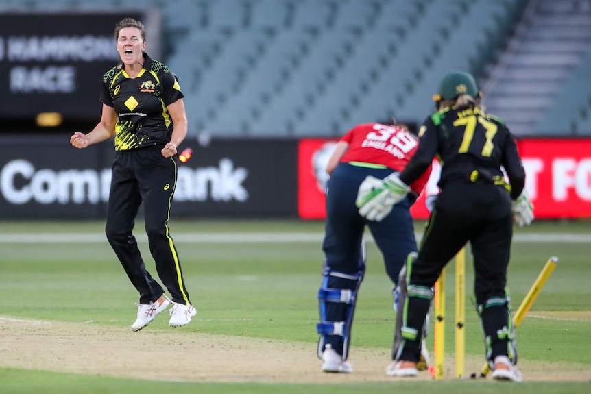 Tahlia McGrath pumps her first and celebrates as a batter's stump is pushed back