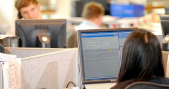 Woman at a computer in an office.