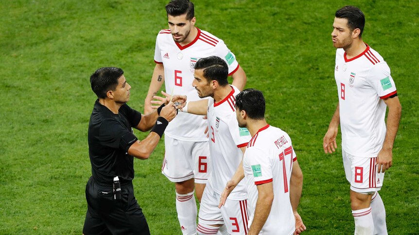 Iranian players surround the ref