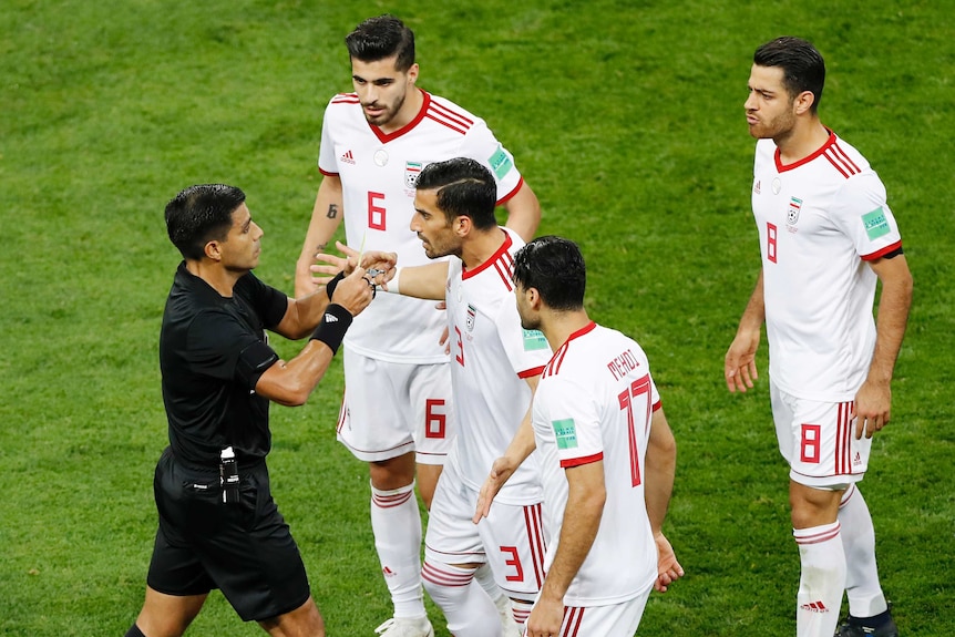 Iranian players surround the ref