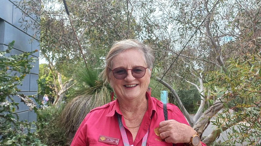 Judy smiles at the camera wearing her official badge.