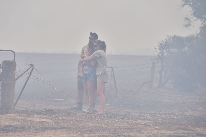 People watch a home at Wasleys, in South Australia, burn during the Pinery bushfire.