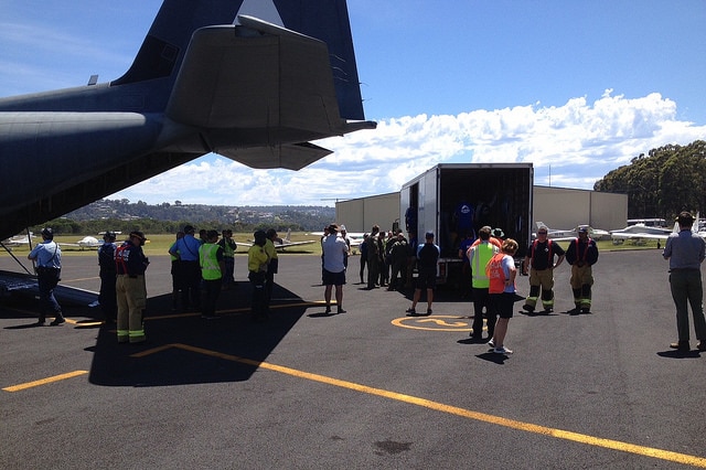 Rescue crews help load a 400 kilo dugong onto a Hercules aircraft