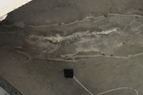 A crack in a concrete ceiling slab.