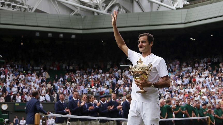 Roger Federer celebrates with the trophy after he defeated Marin Cilic in the final at Wimbledon.