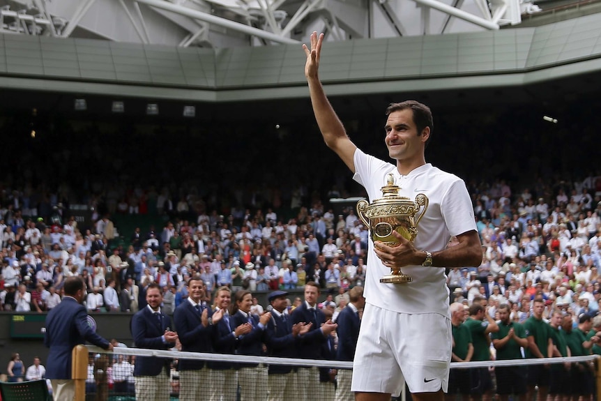 Roger Federer celebrates with the trophy after he defeated Marin Cilic in the final at Wimbledon.