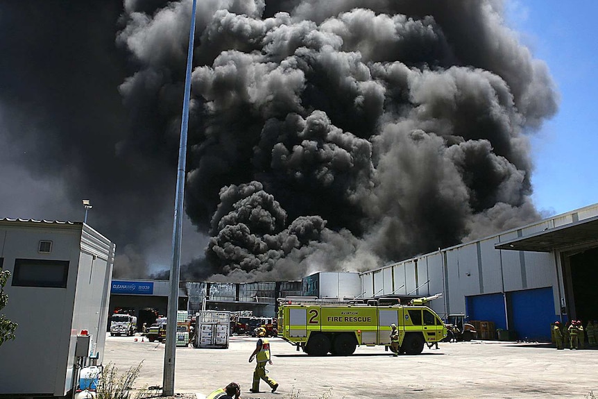 A big plume of smoke above a factory.